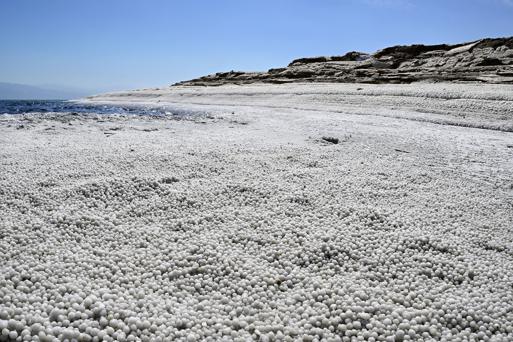 Mer Morte (Israël) - Plage recouverte de petites perles de sel sur le rivage de la Mer Morte 