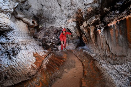 Cueva de sal (Espagne) : spéléo dans galerie avec sel orange au sol et dépôts blancs sur les parois(SP-17-0140)