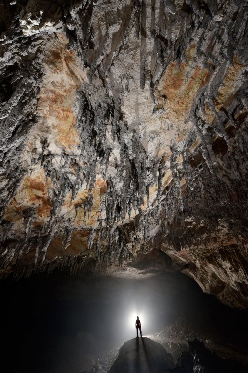 Dimnice Jama (Slovénie) - Plafond orange avec stalactites grises (spéléo en fond en contre-jour avec brouillard)(SP-17-0490)