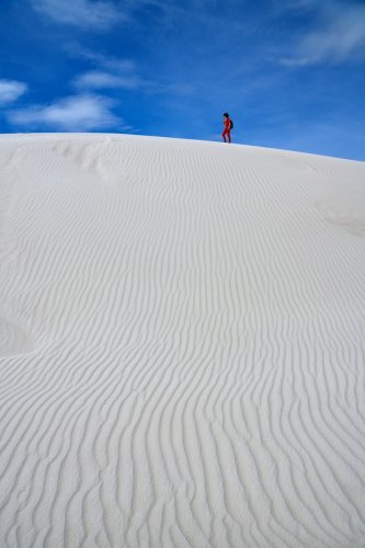 White Sands National Park (Nouveau Mexique, USA) - Dune de sable blanc avec rides en premier plan et personnage en rouge sur la crête(VO-20-0343)