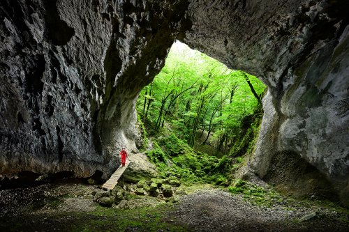 Beaume Archée (Doubs) - Porche d'entrée vu de l'intérieur avec spéléo sur la passerelle(SP-20-0315)