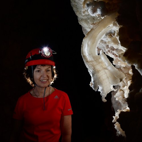 Hell Below Cave (USA - Nouveau Mexique) - Spéléo regardant une crosse de gypse sur la paroi(SP-18-0953)