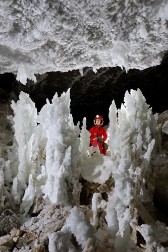Grotte de Geophysicheskaya (Turkménistan) - Galerie blanche: barrière de stalagmites de gypse massives (personnage en arrière plan).(SP-24-1003)