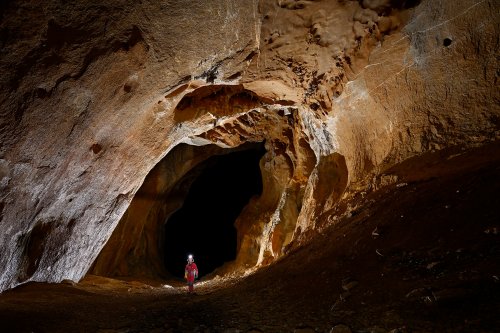 Cueva Canuela (Cantabrie, Espagne) - Grande galerie d'entrée avec spéléo de face.(SP-26-0993)