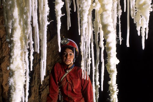Grotte de Pousselières (Hérault) - Spéléologue derrière stalactites d'aragonite(Spe-08020)