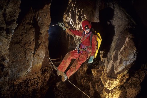Grotte de Pousselières (Aude). Passage sur un pont de singe au dessus d'un gour concrétionné pour le protéger (Mai 2002)(S 07793)